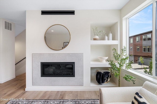 2756 W Lumber Ln Unit 7, Coeur Dalene, ID 83814 - living room featuring wood finished floors, built in features, and a fireplace
