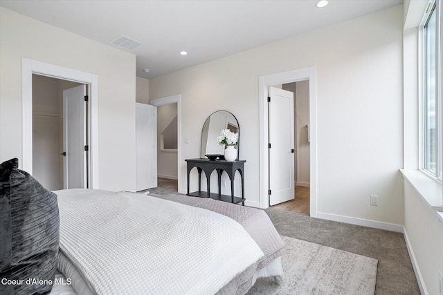 2756 W Lumber Ln Unit 7, Coeur Dalene, ID 83814 - bedroom with a walk in closet, light carpet, a closet, and recessed lighting