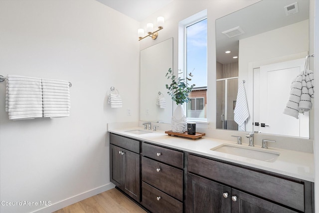 2756 W Lumber Ln Unit 7, Coeur Dalene, ID 83814 - bathroom featuring double vanity, a stall shower, and wood finished floors