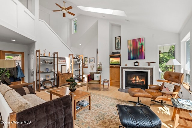 38 S Quail Run Unit B, Sandpoint, ID 83864 - living room with light wood-type flooring, high vaulted ceiling, plenty of natural light, a glass covered fireplace, and ceiling fan