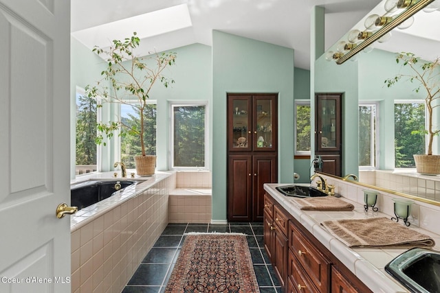 38 S Quail Run Unit B, Sandpoint, ID 83864 - bathroom featuring a bath, healthy amount of natural light, vaulted ceiling, double vanity, and tile patterned floors