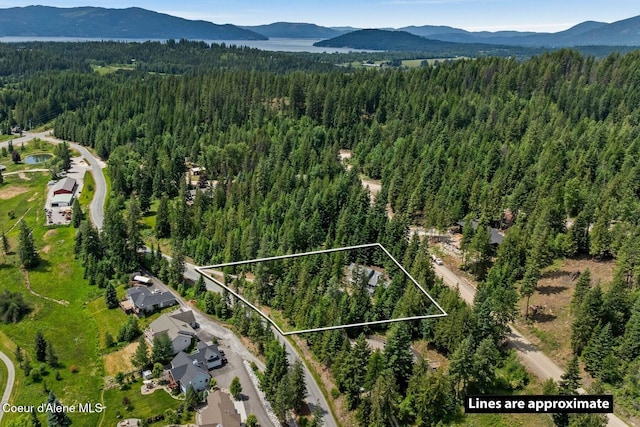 38 S Quail Run Unit B, Sandpoint, ID 83864 - aerial view of property and surrounding area featuring a mountainous background and property boundaries highlighted