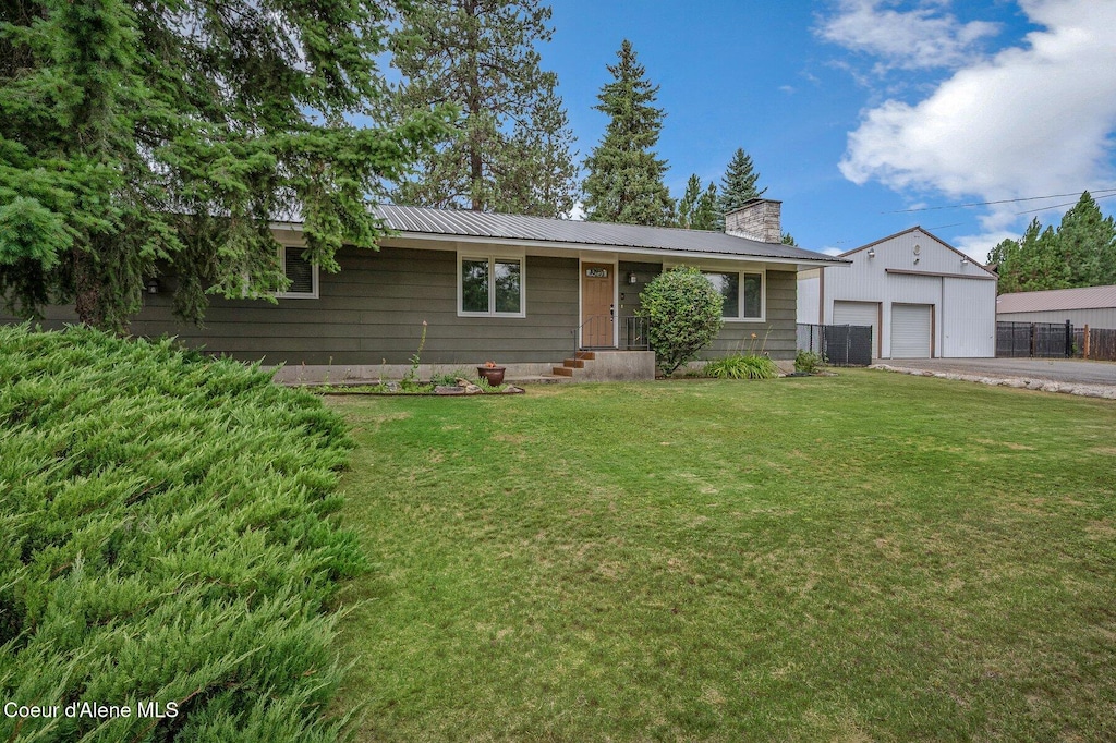 12119 N Burdette Ln, Hauser, ID 83854 - ranch-style home with a chimney, a detached garage, and a metal roof