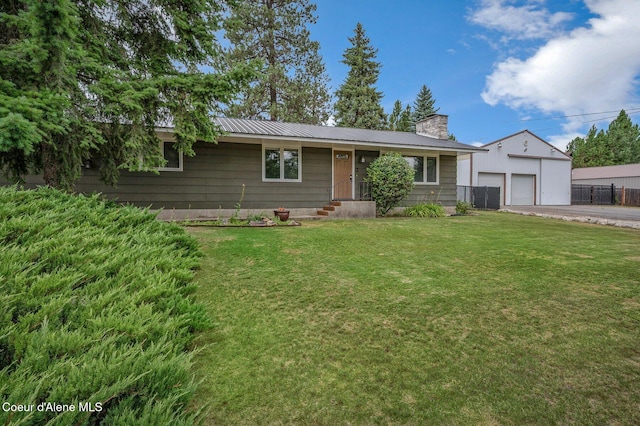 12119 N Burdette Ln, Hauser, ID 83854 - ranch-style home with a chimney, a detached garage, and a metal roof