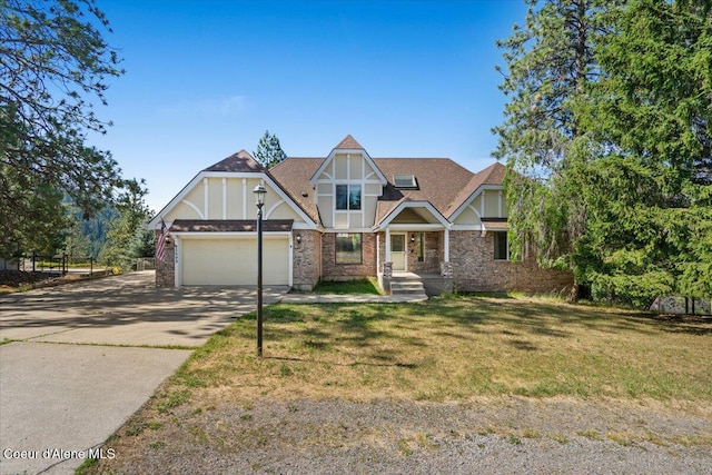 2699 E Packsaddle Dr, Coeur Dalene, ID 83815 - tudor-style house with driveway, a garage, a front lawn, brick siding, and covered porch