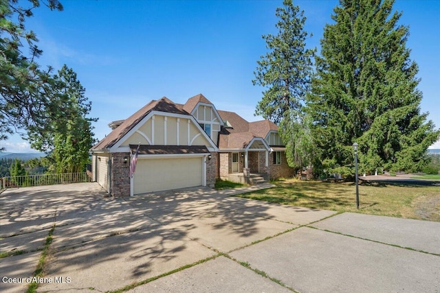 2699 E Packsaddle Dr, Coeur Dalene, ID 83815 - tudor house with concrete driveway, an attached garage, and brick siding