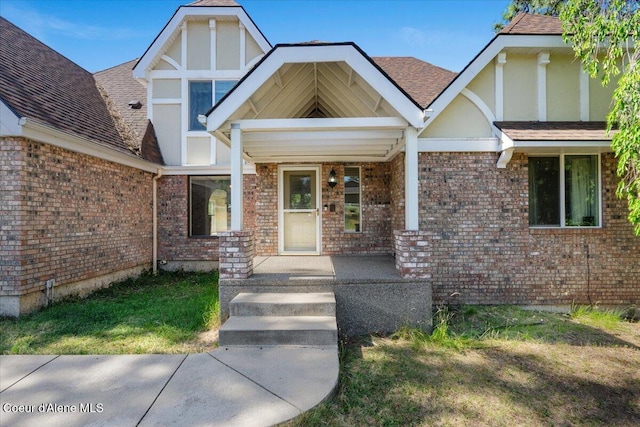 2699 E Packsaddle Dr, Coeur Dalene, ID 83815 - property entrance with brick siding, a porch, a yard, and a shingled roof