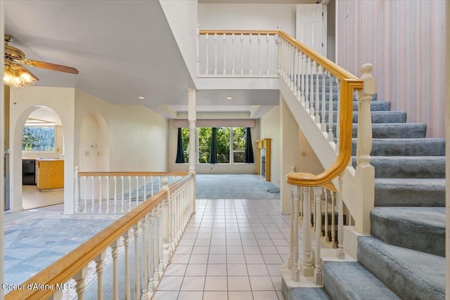 2699 E Packsaddle Dr, Coeur Dalene, ID 83815 - stairway with ceiling fan, carpet flooring, tile patterned floors, arched walkways, and recessed lighting