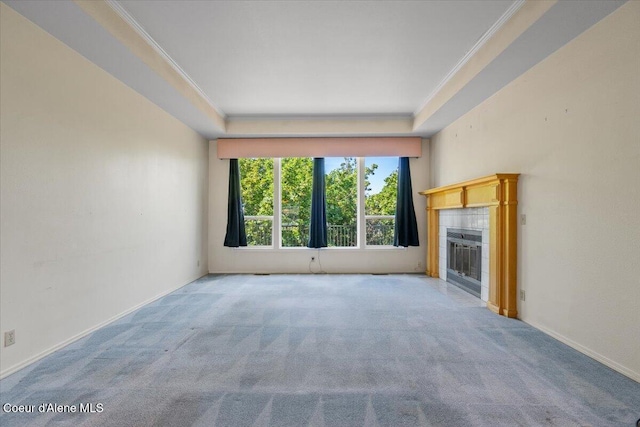 2699 E Packsaddle Dr, Coeur Dalene, ID 83815 - unfurnished living room with carpet flooring, ornamental molding, a tiled fireplace, and a tray ceiling