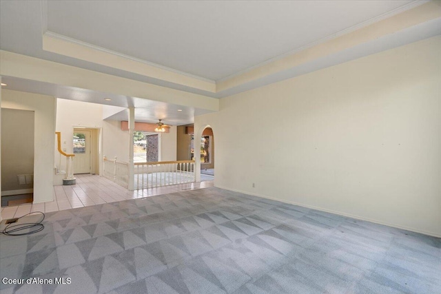 2699 E Packsaddle Dr, Coeur Dalene, ID 83815 - unfurnished living room featuring crown molding, light carpet, arched walkways, ceiling fan, and light tile patterned floors