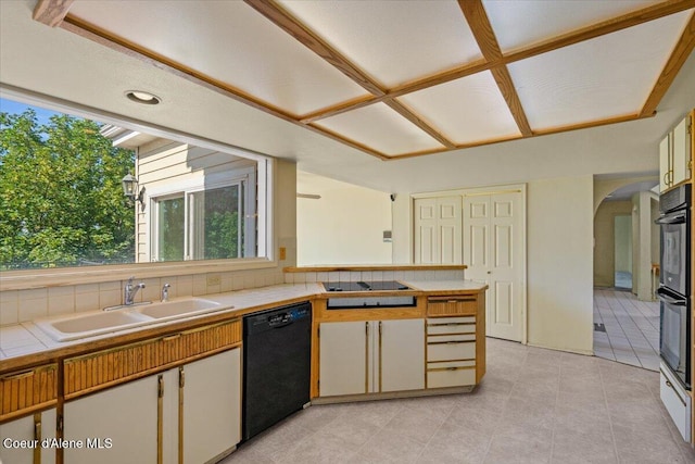 2699 E Packsaddle Dr, Coeur Dalene, ID 83815 - kitchen featuring black appliances, tile counters, arched walkways, light tile patterned floors, and a peninsula