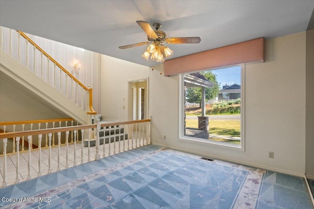 2699 E Packsaddle Dr, Coeur Dalene, ID 83815 - unfurnished living room with stairs, a ceiling fan, and carpet floors