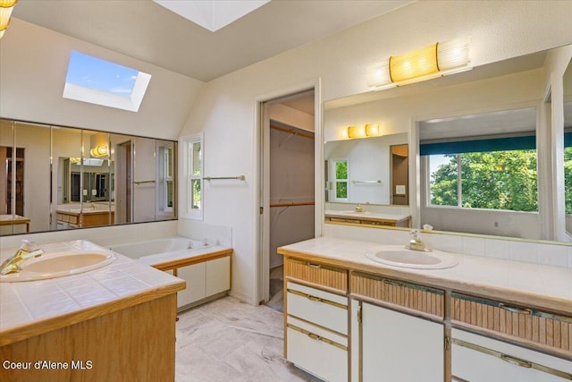 2699 E Packsaddle Dr, Coeur Dalene, ID 83815 - full bath featuring a skylight, two vanities, a bath, and vaulted ceiling