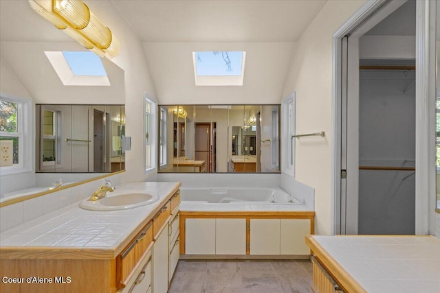 2699 E Packsaddle Dr, Coeur Dalene, ID 83815 - bathroom featuring a skylight, vanity, a bath, vaulted ceiling, and marble finish floors
