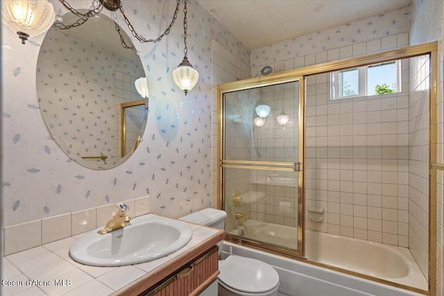 2699 E Packsaddle Dr, Coeur Dalene, ID 83815 - full bathroom with wallpapered walls, vanity, and bath / shower combo with glass door