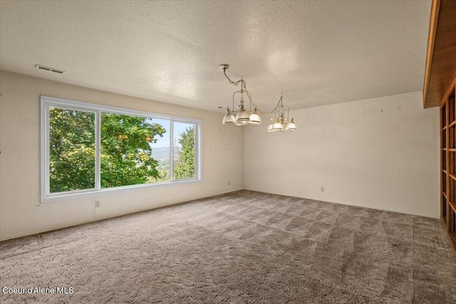 2699 E Packsaddle Dr, Coeur Dalene, ID 83815 - spare room featuring a chandelier, carpet flooring, and a textured ceiling