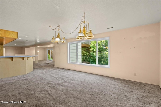 2699 E Packsaddle Dr, Coeur Dalene, ID 83815 - unfurnished living room with a chandelier and carpet