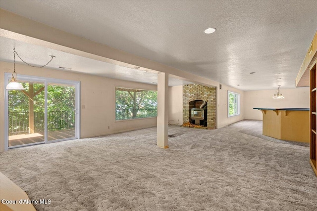 2699 E Packsaddle Dr, Coeur Dalene, ID 83815 - unfurnished living room featuring light carpet, a textured ceiling, and a chandelier