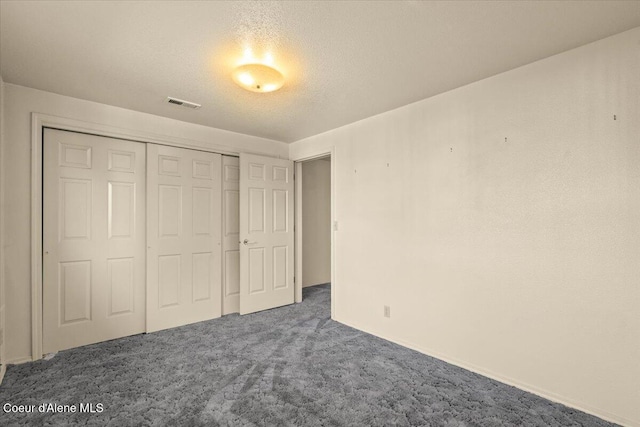 2699 E Packsaddle Dr, Coeur Dalene, ID 83815 - unfurnished bedroom with carpet, a closet, and a textured ceiling