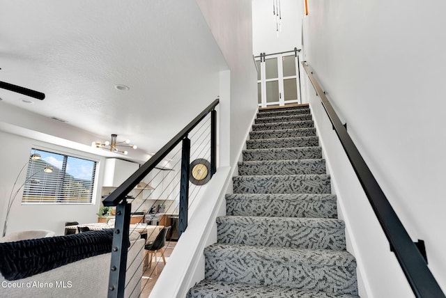 114 E Hattie, Coeur Dalene, ID 83814 - stairway with a chandelier and a ceiling fan