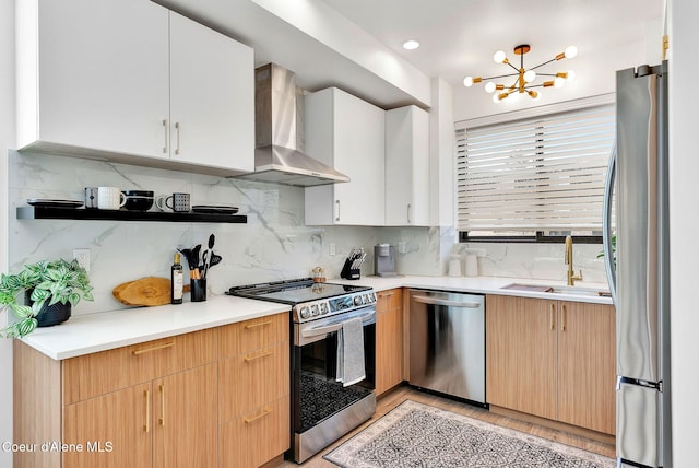 114 E Hattie, Coeur Dalene, ID 83814 - kitchen featuring appliances with stainless steel finishes, wall chimney exhaust hood, a chandelier, backsplash, and light countertops