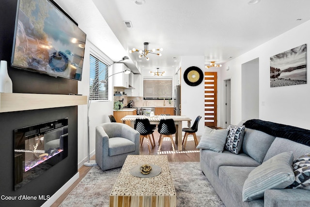 114 E Hattie, Coeur Dalene, ID 83814 - living room with a chandelier and light wood-type flooring