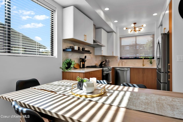 114 E Hattie, Coeur Dalene, ID 83814 - dining room with healthy amount of natural light, a chandelier, and recessed lighting