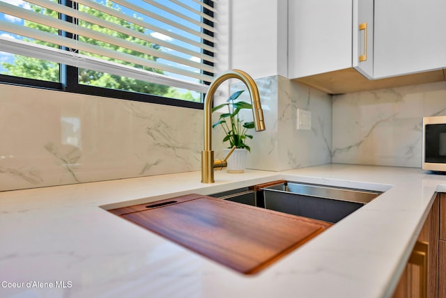 114 E Hattie, Coeur Dalene, ID 83814 - kitchen featuring backsplash and white cabinetry