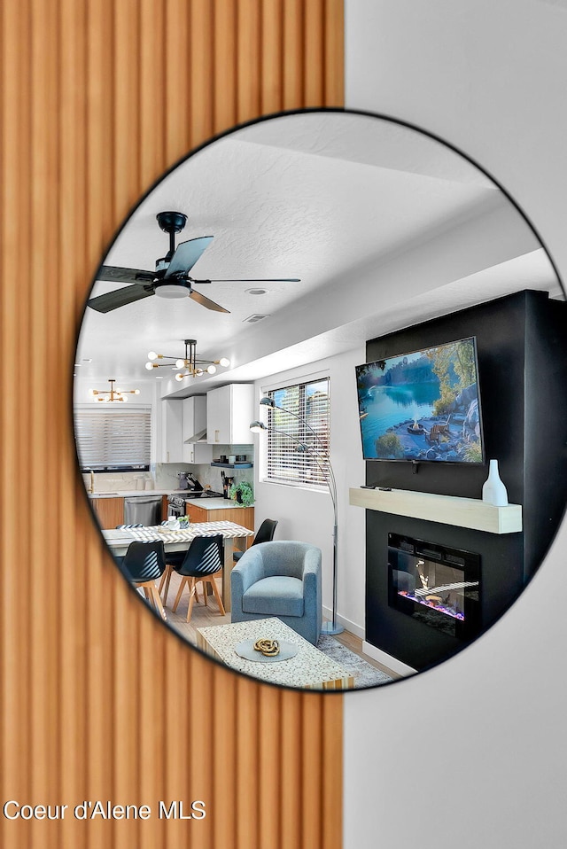 114 E Hattie, Coeur Dalene, ID 83814 - living area featuring a glass covered fireplace and ceiling fan