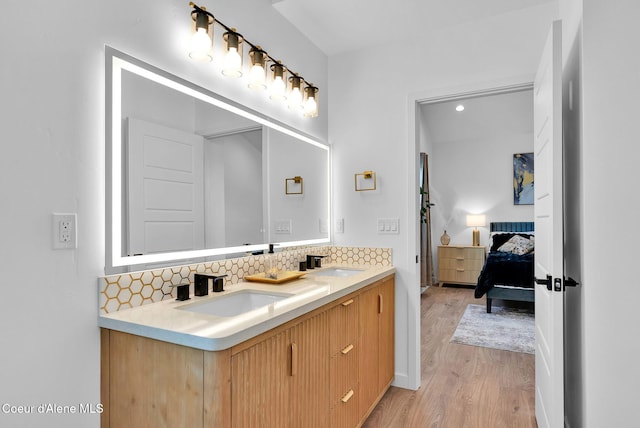 114 E Hattie, Coeur Dalene, ID 83814 - ensuite bathroom featuring double vanity, tasteful backsplash, and wood finished floors