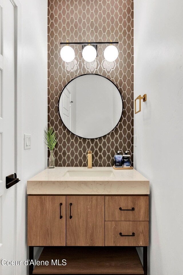 114 E Hattie, Coeur Dalene, ID 83814 - bathroom with vanity and tasteful backsplash