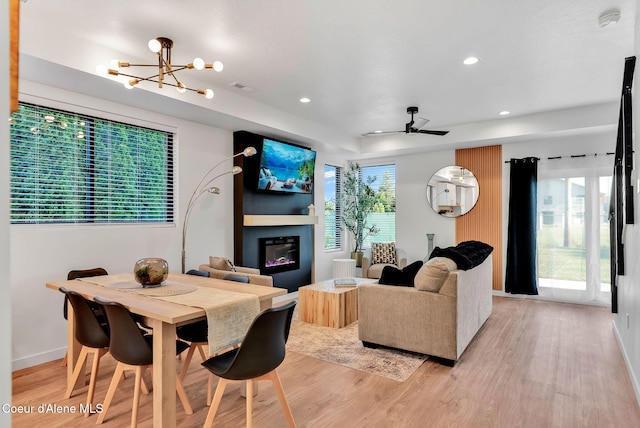 114 E Hattie, Coeur Dalene, ID 83814 - dining area with light wood-style floors, a glass covered fireplace, a chandelier, recessed lighting, and ceiling fan