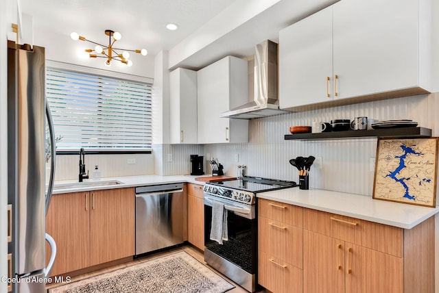 114 E Hattie, Coeur Dalene, ID 83814 - kitchen featuring appliances with stainless steel finishes, wall chimney range hood, tasteful backsplash, a chandelier, and light countertops