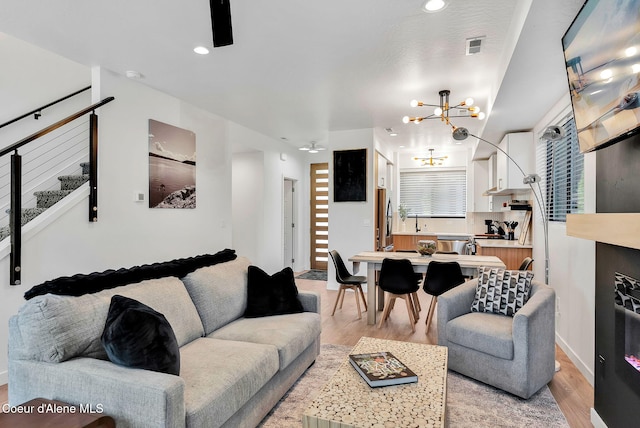 114 E Hattie, Coeur Dalene, ID 83814 - living area with light wood-type flooring, a chandelier, and recessed lighting