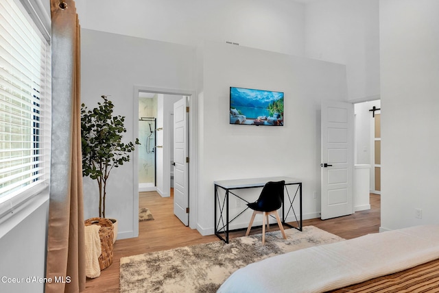 114 E Hattie, Coeur Dalene, ID 83814 - bedroom featuring wood finished floors, a towering ceiling, and a barn door
