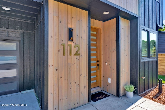 114 E Hattie, Coeur Dalene, ID 83814 - doorway to property featuring board and batten siding