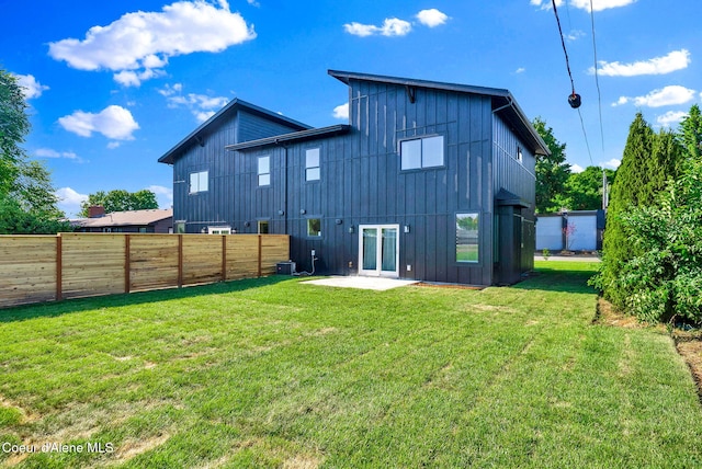 114 E Hattie, Coeur Dalene, ID 83814 - back of house featuring board and batten siding, a fenced backyard, and a patio area