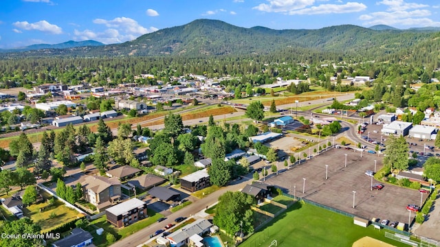 114 E Hattie, Coeur Dalene, ID 83814 - aerial view of property and surrounding area featuring a mountain backdrop and a heavily wooded area