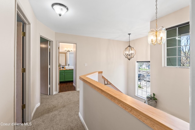 703 W Angus Ct, Post Falls, ID 83854 - hallway featuring an upstairs landing, a chandelier, carpet, and plenty of natural light