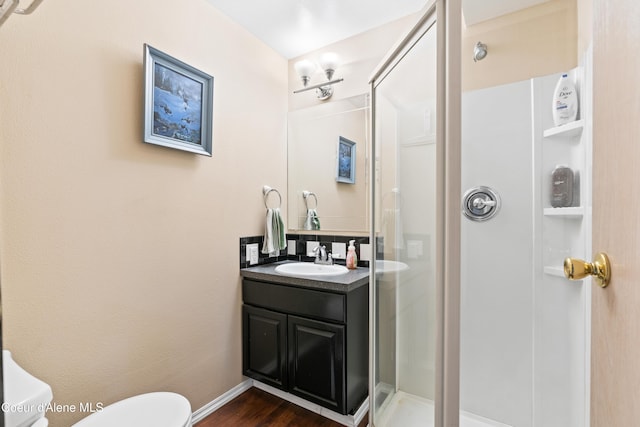 703 W Angus Ct, Post Falls, ID 83854 - bathroom with a stall shower, vanity, and wood finished floors