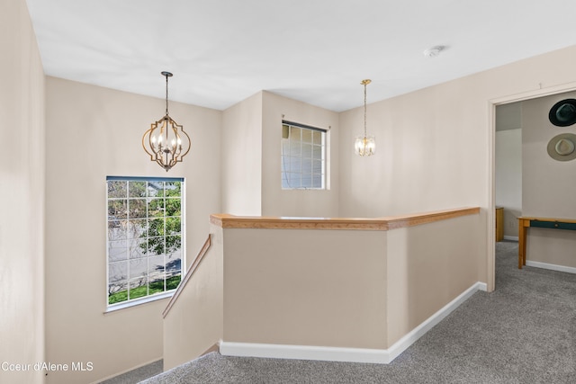 703 W Angus Ct, Post Falls, ID 83854 - corridor with a chandelier, an upstairs landing, and carpet