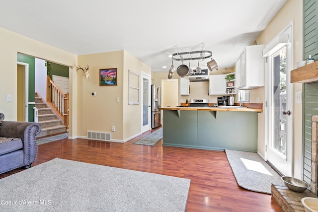 703 W Angus Ct, Post Falls, ID 83854 - living room featuring dark wood-style floors and stairway