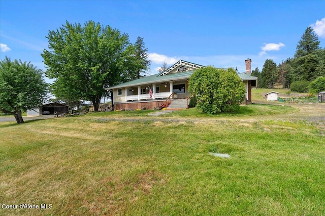 3297 Minaloosa Valley Rd, Plummer, ID 83851 - view of front facade featuring covered porch, a front yard, a chimney, and a metal roof