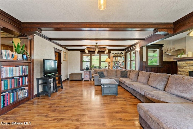 3297 Minaloosa Valley Rd, Plummer, ID 83851 - living room with a textured ceiling, wood finished floors, crown molding, beamed ceiling, and a chandelier