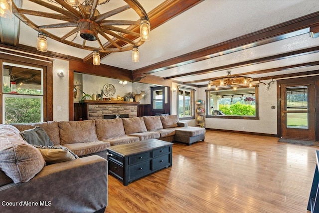 3297 Minaloosa Valley Rd, Plummer, ID 83851 - living area with beamed ceiling, light wood-style floors, ornamental molding, and a stone fireplace