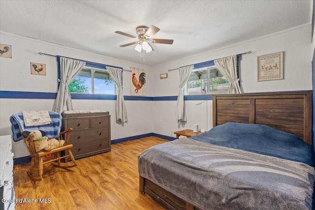 3297 Minaloosa Valley Rd, Plummer, ID 83851 - bedroom featuring multiple windows, a textured ceiling, wood finished floors, crown molding, and ceiling fan