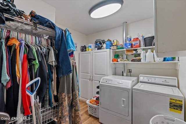 3297 Minaloosa Valley Rd, Plummer, ID 83851 - laundry room featuring cabinet space, washing machine and dryer, and light wood-type flooring