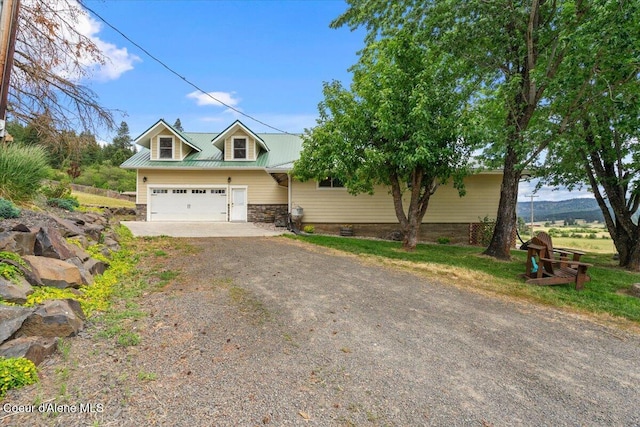 3297 Minaloosa Valley Rd, Plummer, ID 83851 - view of front of property featuring dirt driveway, stone siding, an attached garage, and a metal roof
