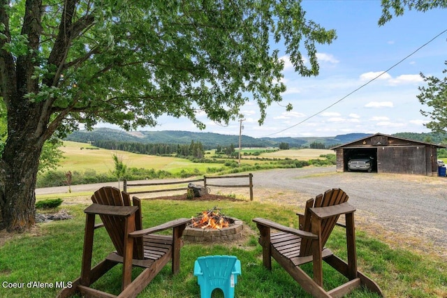 3297 Minaloosa Valley Rd, Plummer, ID 83851 - view of yard with a fire pit, a view of rural / pastoral area, a mountain view, an outdoor structure, and gravel driveway