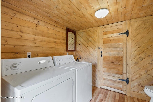 3297 Minaloosa Valley Rd, Plummer, ID 83851 - laundry room with wooden ceiling, independent washer and dryer, wood walls, and light wood finished floors